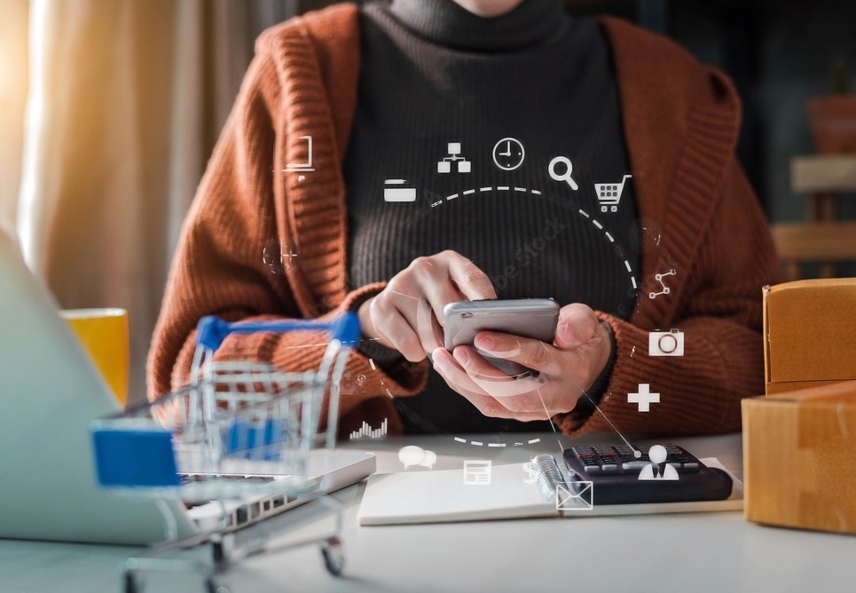 a woman holding phone on the desk