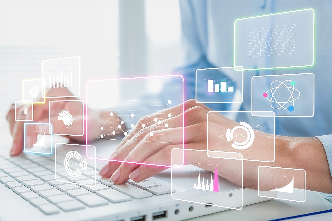 hand type on a kewboard with graph, chart as a hologram