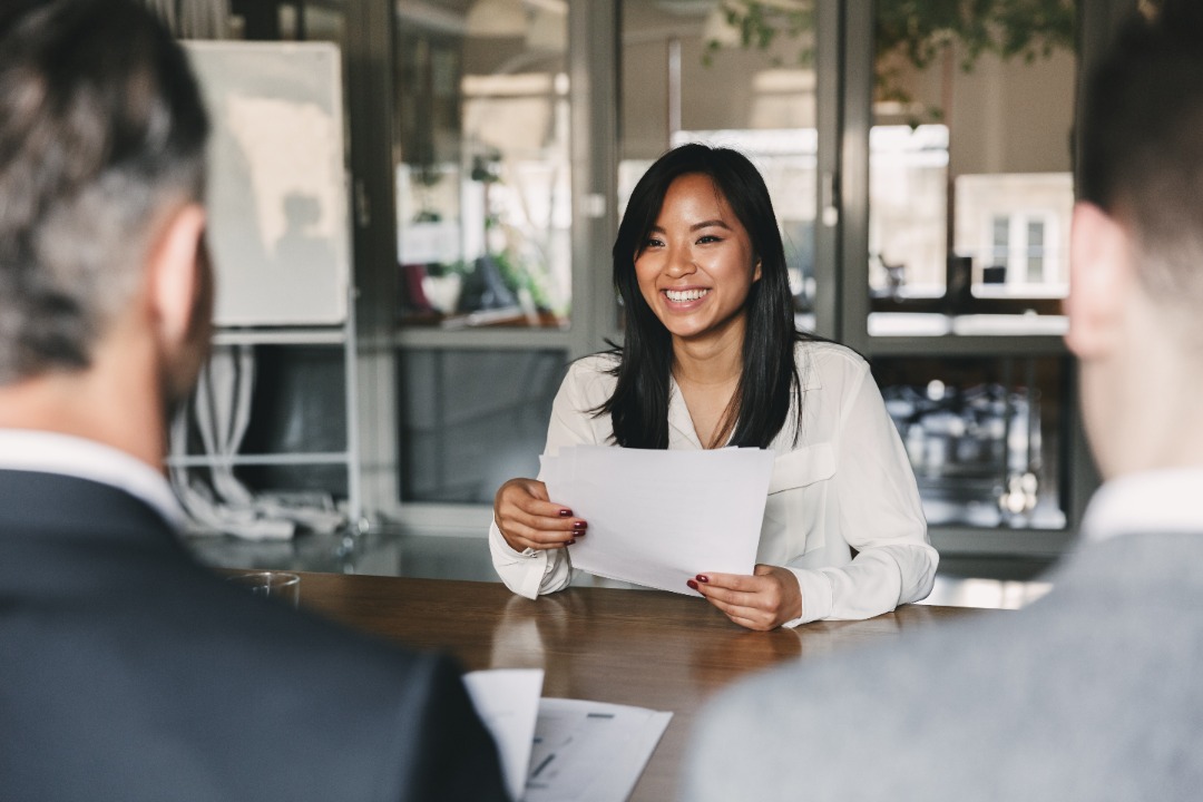 woman in meeting with 2 men